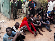 Inmates who escaped during the attack by suspected Boko haram fighters wait after being captured and returned back to Kuje prison, in Abuja, Nigeria July 6, 2022
