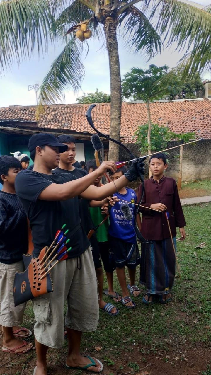 Quality check: Obby Rodyana tests his arrows with neighborhood kids. (Courtesy of Obby Rodyana)
