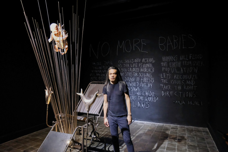 Suspended impressions: Artist Jay Subiyakto poses in front of his installation piece titled 'No More Babies' at the 2022 ARTJOG Festival. (Courtesy of ARTJOG Festival)