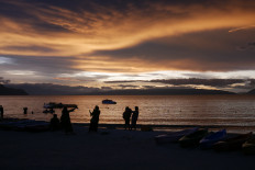 Golden hour: A number of domestic tourists are seen enjoying the sunset  at Bulbul Beach on at Lake Toba, in Balige, Toba Regency, in June 2024. (JP/Tonggo Simangunsong)