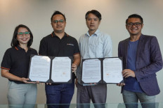 General manager of Pashouses Shirley Pranoto (left), COO and cofounder of Pashouses Bin Anindita (second left), chief transformation officer of Sinar Mas Land Mulyawan Gani (second right) and Bayu Seto, a representative of Living Lab Ventures, hold up a signed collaboration  agreement.
