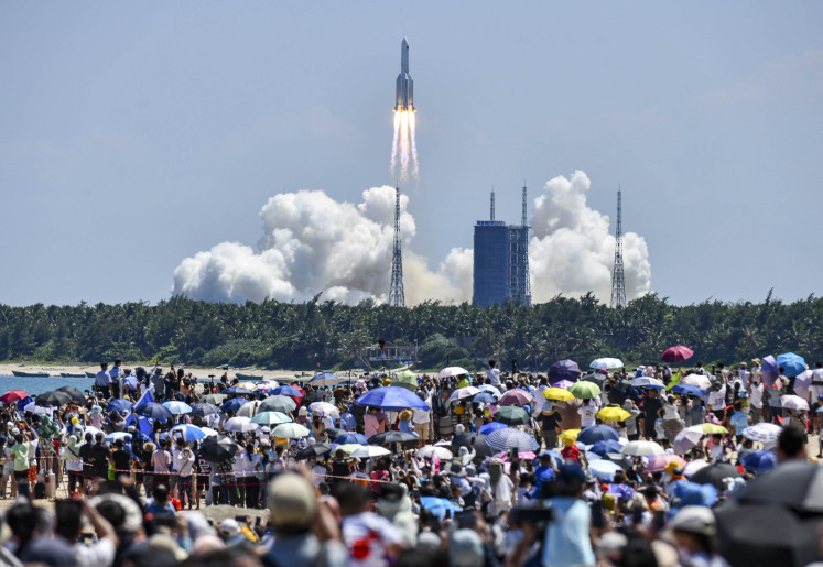 Onlookers watch the launch of a rocket transporting China&rsquo;s second module for its Tiangong space station from the Wenchang spaceport in southern China on July 24, 2022. 