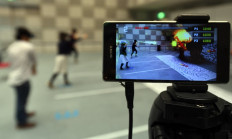 Visitors play a game called 'Hado' during the Wearable Tech Expo in Tokyo 2015 exhibition in Tokyo on September 7, 2015.