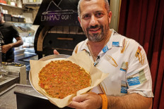 What’s cooking: Nassar Odeh, owner of the Taboon wine bar and restaurant, holds a vegan version of the lahmajoun (meat on dough) popular Middle Eastern flatbread, while posing for a photo at his venue in the Old City of Jerusalem on July 26.