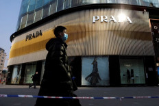 ‘Fashion statement’: A man wearing a face mask following the COVID-19 outbreak walks past a store of Italian luxury brand Prada on a shopping street in Beijing, China, on Jan. 20, 2021. 