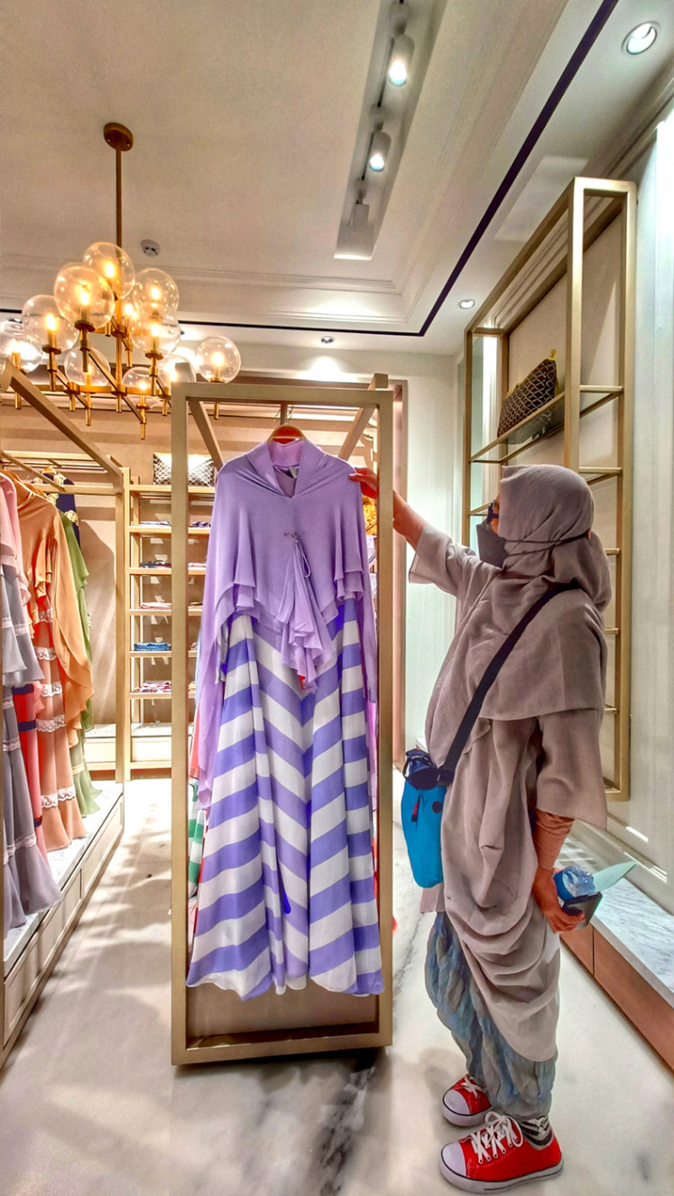Striking style: A woman looks at a dress-and-khimar outfit on display in modest fashion brand Si.Se.Sa’s new flagship boutique. (JP/Sylviana Hamdani)