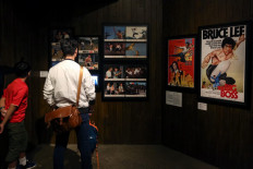 His legacy goes on: Visitors look at posters of kung-fu action-hero Bruce Lee's films at a museum in Hong Kong on Nov. 3, 2018. 