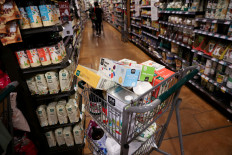 A shopping cart stands in a supermarket in Manhattan, New York City, US, on June 10, 2022. The latest consumer price index revealed a slowdown in US inflation in July, lifting stock markets in the US and Asia.