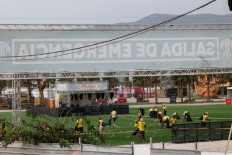 Dangerous gale: Workers clean the venue of Medusa Festival, an electronic music festival in Cullera, near Valencia, Spain, after high winds caused part of a stage to collapse on Saturday.