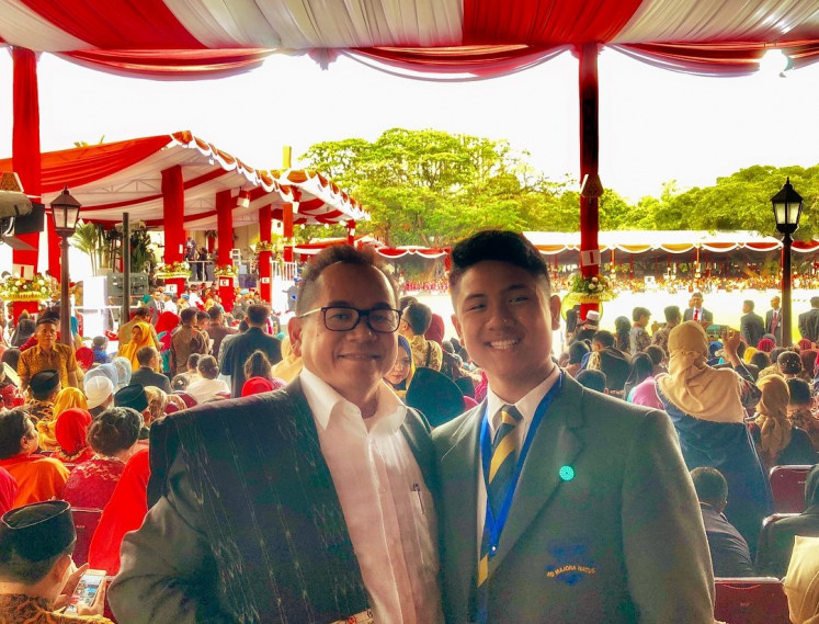 Culture: Frans Simarmata (left) and his son Xavier Simarmata (right) attend the Independence Day of Indonesia in 2018 at Merdeka Palace, Jakarta. Attending Indonesia’s cultural events is one of the ways Frans teaches his children about being nationalist. (Courtesy of Frans Simarmata) 
