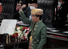 President Joko "Jokowi" Widodo, wearing traditional attire from Bangka Belitung Islands, gestures as he delivers his State Address ahead of the country's Independence Day at the House of Representatives building in Jakarta, on Tuesday.