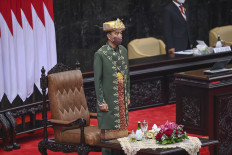President Joko “Jokowi” Widodo, in traditional Bangka Belitung dress, stands prior to delivering his annual State Address before the country’s executive, legislative and judicial branches at the House of Representatives complex in Jakarta on Aug. 16. 
