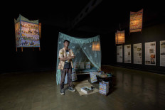 Evoking Masmundar: Novan Effendy poses with his installation at the Biennale Jogja XVI, held in October 2021 in Yogyakarta. The piece was a tribute to the late Damara Kurung master artisan, Sriwati Masmundar, and reproduced her bedroom. (Courtesy Damar Kurung Institute)