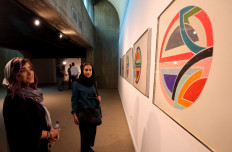 Visitors look at Sinjerli Variations I-V, by American painter Frank Stella in 1977, during the 'Minimalism and Conceptual Art' exhibition, which showcases works from the 19th and 20th-centuries by American and European artists, at the Tehran Museum of Contemporary Art in the Iranian capital on August 22, 2022.