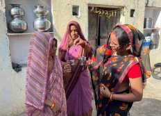 Monica Prajapati, Suraj Prajapati and Anjana Prajapati, members of Village Water and Sanitation Committee, conduct a test on a water sample inside a house in Manda Bhopawas village in the Indian desert state of Rajasthan, India,