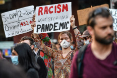 Demonstrators attend a Black Lives Matter protest to express solidarity with US protestors in Sydney on June 6, 2020 and demand an end to frequent Aboriginal deaths in custody in Australia. 
