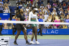 USA's Serena Williams (left) and Venus Williams leave the court after their loss against Czech Republic's Lucie Hradecka and Linda Noskova during their 2022 US Open Tennis tournament women's doubles first round match at the USTA Billie Jean King National Tennis Center in New York, on September 1, 2022. 