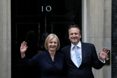 Another chapter: Standing outside 10 Downing Street, the United Kingdom's newly appointed Prime Minister Liz Truss poses for photographers with her husband Hugh O'Leary after delivering her first speech as prime minister in central London, on Sept. 6.

