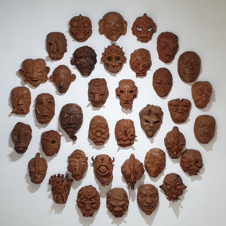 Artwork: “Topeng Pandemi” 2021-2022, a terracotta mask installation by Kelompok Seni Gotong Royong and school children, is on display at Pintu Saren Art Space.  (JP/Richard Horstmann)