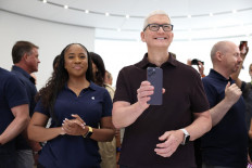 Apple CEO Tim Cook holds a new iPhone 14 Pro during an Apple special event on September 07, 2022 in Cupertino, California.