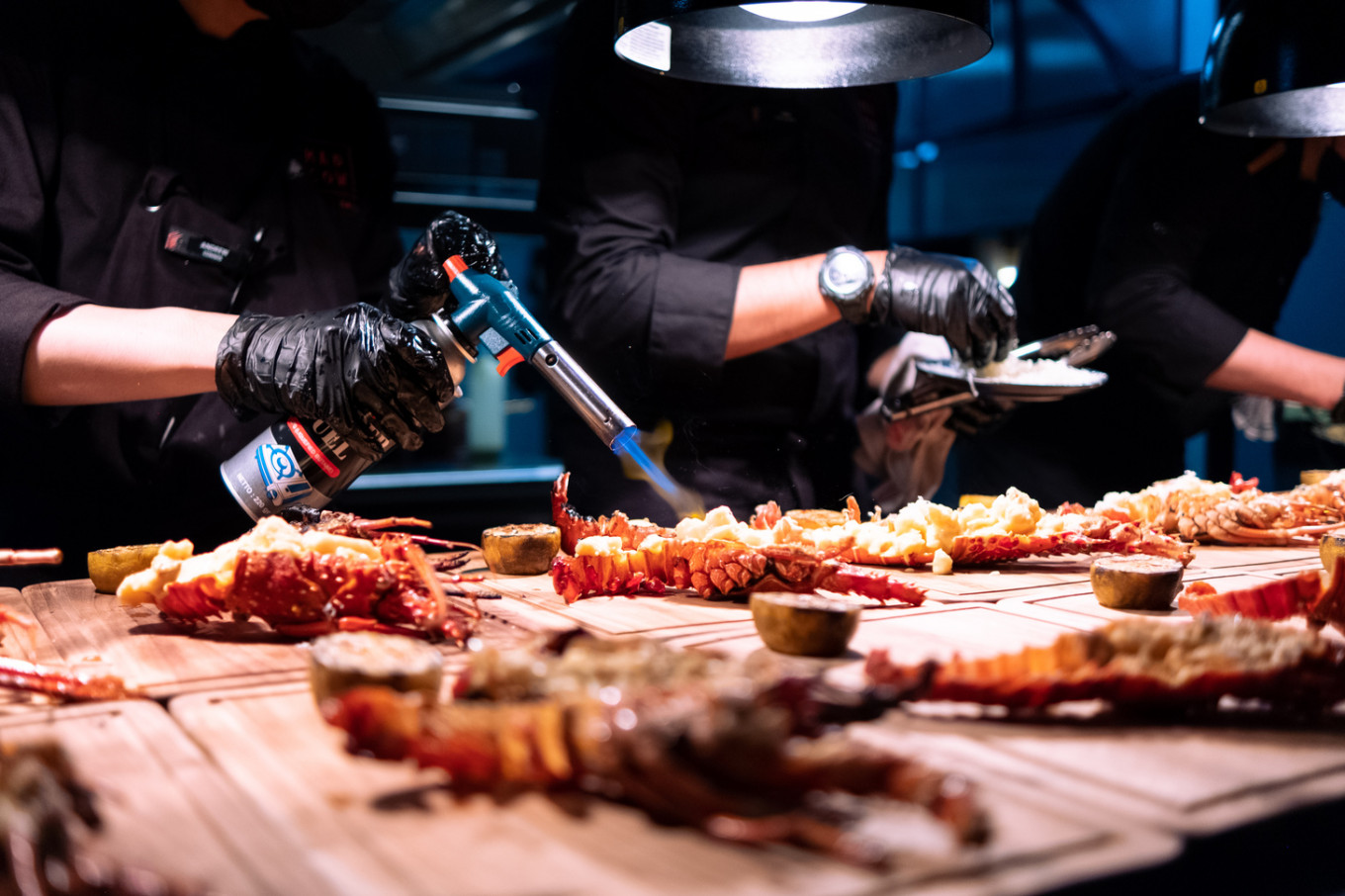 Finishing touches: Mad Cow's kitchen crew torch the lobsters before being served. (Courtesy of Mad Cow Bandung)