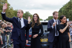 (Left-right) Britain's Prince William, Prince of Wales, Britain's Catherine, Princess of Wales, Britain's Prince Harry, Duke of Sussex, Britain's Meghan, Duchess of Sussex, wave at well-wishers on the Long walk at Windsor Castle on September 10, 2022. King Charles III pledged to follow his mother's example of 