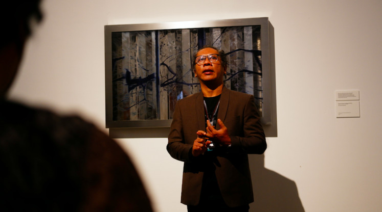 The harbinger(s) of doom: One of the curators of Bandung Photography Triennale 2022, Henrycus Napitsunargo, presents the work by Utami Dewi Godjali titled 'Virtual Insanity'   (2022) during the grand opening's curatorial tour, on Sept. 8. (JP/Anindito Ariwandono)