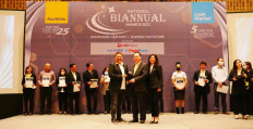 Winners of the 2022 National Biannual Awards are recognized on stage for their hard work and commitment.