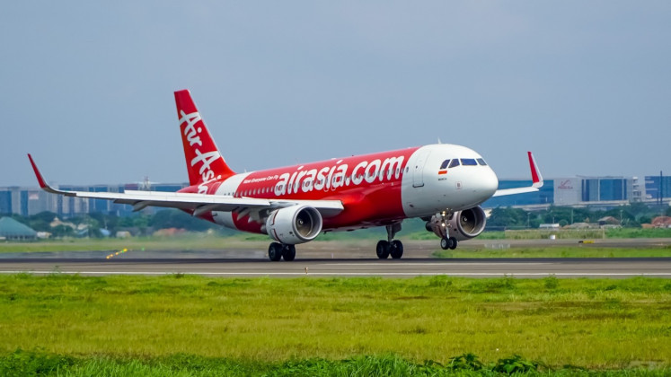An Airbus 320-200 operated by Indonesia AirAsia lands at Jakarta-serving Soekarno-Hatta International Airport. (JP/Abdur Rahim)