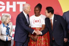 EU Commission President Ursula von der Leyen (left) and (RED) Amabassador and AIDS activist Connie Mudenda (2nd R) look on as US President Joe Biden (2nd L) shakes hands with South Korean President Yoon Suk-yeol at the Global Fund's Seventh Replenishment Conference in New York City on September 21, 2022.