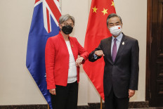 Australia's Foreign Minister Penny Wong (left) bumps elbows with China's Foreign Minister Wang Yi during their bilateral meeting on the sidelines of G20 Foreign Ministers Meeting in Nusa Dua in Bali on July 8, 2022. 

