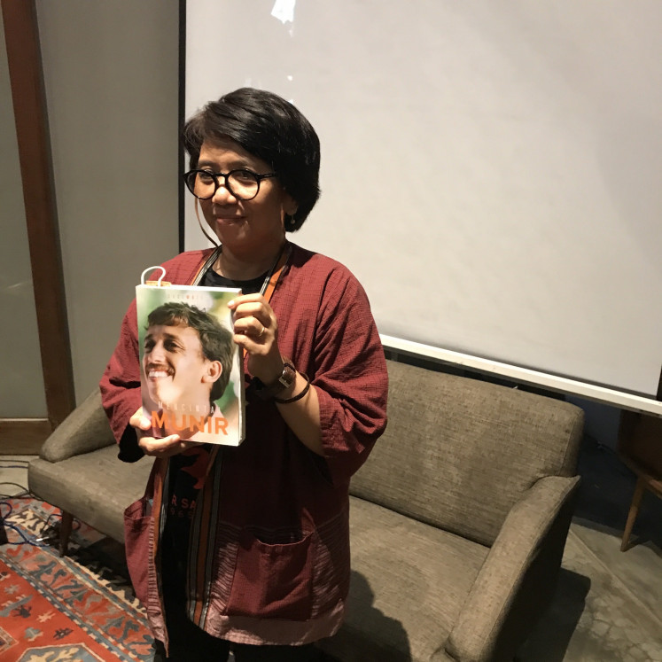 Remembering Munir: Munir’s widow Suciwati poses with an edition of 'Mencintai Munir' during the book launch at Dia.lo.gue Artspace in South Jakarta on Sept. 14. (JP/Tunggul Wirajuda)