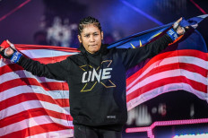 Jihin Radzuan carries Malaysia’s flag as she walks into ONE Championship’s Circle to face Itsuki Hirata at ONE X in March. 