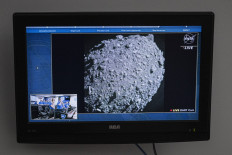 A television at NASA's Kennedy Space Center in Cape Canaveral, Florida, captures the final images from the Double Asteroid Redirection Test (DART) just before it smashes into the asteroid Dimorphos on September 26, 2022. NASA's DART spaceship on September 26 struck the moonlet asteroid Dimorphos, in a historic test of humanity's ability to prevent a cosmic object devastating life on Earth.
