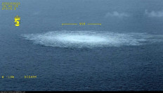 This handout photo released on September 27, 2022 and taken from an aircraft of the Swedish Coast Guard (Kustbevakningen) shows the release of gas emanating from a leak on a Nord Stream gas pipeline, with the leak measuring over 950 meters in diameter, in the Swedish economic zone in the Baltic Sea, near the Danish island of Bornholm. 