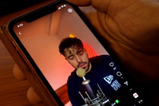 A man watches a video of Iranian singer Shervin Hajipour, who was released in Tehran today after being arrested for his song in support of protests over the death of Mahsa Amini, in the Cypriot capital Nicosia on October 4, 2022. Hajipour, a 25-year-old Iranian pop singer and songwriter, rose to fame for the song 