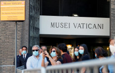 People wearing protective face masks queue to The Vatican Museums ahead of the re-opening amid the spread of the coronavirus disease (COVID-19) in Rome, Italy June 1, 2020 