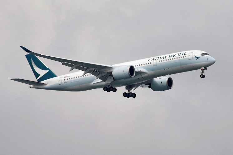 A Cathay Pacific Airways Airbus A350-900 approaches to land at Changi International Airport in Singapore on June 10, 2018.
