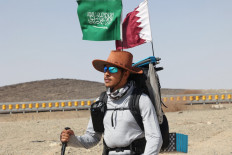 Saudi trekker Abdullah Alsulmi crosses a desert area near al-Khasrah area, some 350Km west of Riyadh, on Septembre 27, 2022, during his solo trek to the Qatari capital ahead of the FIFA World Cup.