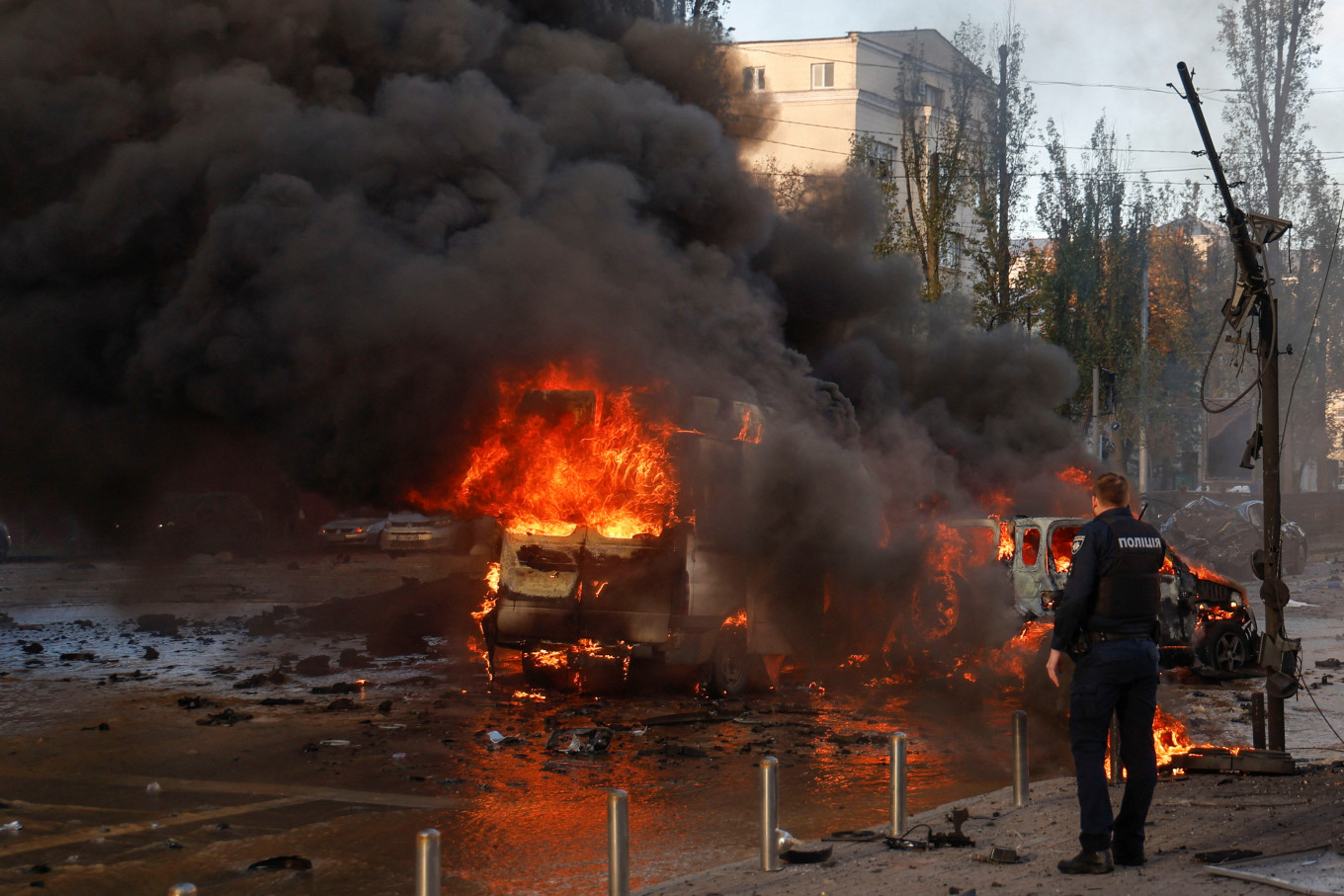 Cars are seen on fire after Russian missile strikes, as Russia's attacks on Ukraine continue, in Kyiv on Oct. 10. 