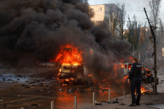 Cars are seen on fire after Russian missile strikes, as Russia's attack continues, in Kyiv, Ukraine October 10, 2022. 