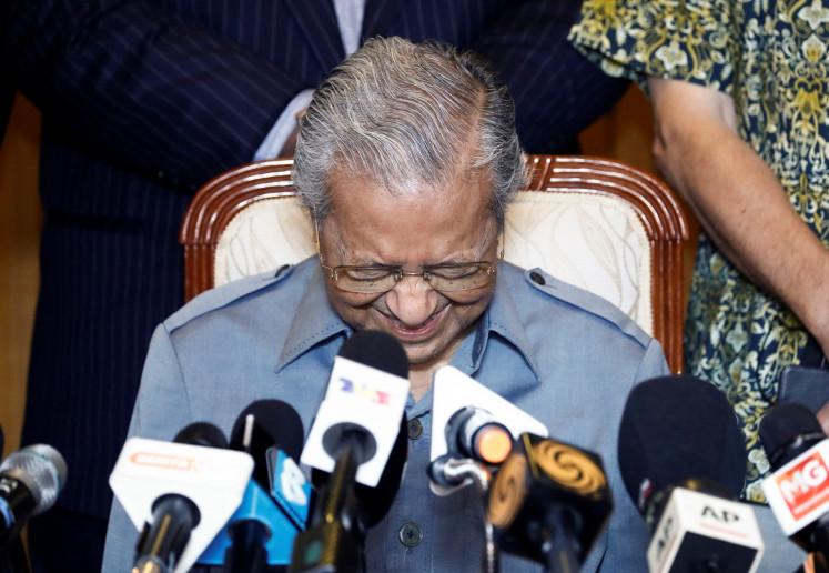 Former Malaysian Prime Minister Mahathir Mohamad reacts during a news conference at Putrajaya, Malaysia 