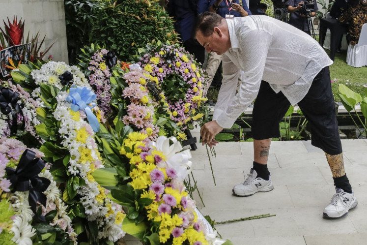 Australian Bali bombing survivor Andrew Csabi lays flowers during a commemoration ceremony to mark the 20th anniversary of the Bali bombings that killed more than 200 people, at the Australian consulate in Denpasar in Bali on Oct. 12, 2022. 
