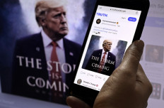 Available on Google Playstore: Donald Trump's Truth Social account is seen on a mobile device with an image of former US president Donald Trump in the background in Washington, DC on Sept. 13. 