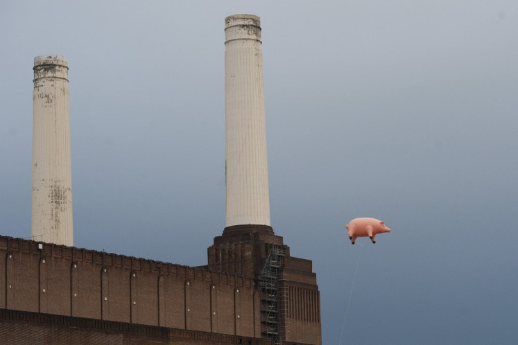 An inflatable pig floats above Battersea Power Station in London, on September 26, 2011, during a photocall to promote the release of remastered albums and previously unreleased music by British rock band 'Pink Floyd'. The floating pig above Battersea Power Station was originally used by the band on the cover of their 1976 album 'Animals'. 