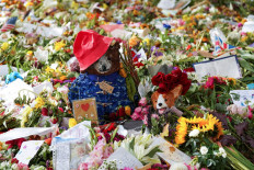 Beloved bear: Paddington Bear sits among other tributes at Green Park, following the funeral of Queen Elizabeth II, in London, the United Kingdom, on Sept. 23.