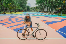 Street artist: Adi Dharma, best known as Stereoflow, poses on the sports field he painted at Taman Menteng, Central Jakarta. (Courtesy of Mahavisual)