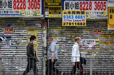 Pedestrians walk past closed down shoplots in Hong Kong, China, on Oct. 19, 2022.
