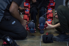 New hope: Physical therapists prepare the robotic exoskeleton Atlas 2030 during a rehabilitation session at the Association for People with Cerebral Palsy (APAC) in Mexico City on Oct. 18.