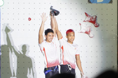 All-Indonesian finalists Kiromal Katibin (left) and Aspar Jaelolo (right) wave to the crowd as the two finish just a split second apart in the Jakarta leg of the IFSC World Cup 2022 on Sep. 26, 2022. Aspar defeated Kiromal to bring home the gold medal after clocking in at 5.39 seconds. 